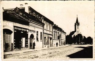 1941 Szászrégen, Reghin; utca, templom, Philippi & Langer könyvnyomda üzlete / street view, church, shops (fl)