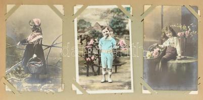 164 db RÉGI képeslap vegyes minőségben kis szecessziós albumban: sok dombornyomott és litho üdvözlő,...