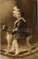 Kislány hintalovon / girl on rocking horse, photo