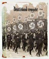 1933 Deutschland erwacht - Werden, Kampf und Sieg der NSDAP. A Nemzetiszocialista Német Munkáspárt (náci párt) hatalomra jutása alkalmából kiadott propaganda gyűjtőkép-album, kb. 70-80 db képpel (rajtuk Adolf Hitler, NSDAP pártrendezvények, ünnepségek, Hitlerjugend, stb.), a képek többsége nincs beragasztva. Kiadói egészvászon-kötésben, jó állapotban, eredeti, sérült kiadói papír védőborítóval. / 1933 Nazi Party commemorative album, with approx. 70-80 collectible pictures. Linen binding, in good condition, with original, sligthly damaged paper cover.
