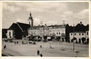 1943 Kézdivásárhely, Targu Secuiesc; Fő tér, országzászló, autók, Nagy I. hentes, Jencsevics cukrászda, A. Páll Sándor üzlete, gyógyszertár / main square, Hungarian flag, automboiles, butcher, shops, confectionery, pharmacy (ragasztónyomok / gluemarks)