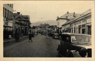 Huszt, Chust, Khust; Fő utca, Cikta, üzletek, automobilok / main street, shops, automobiles. photo (fl)