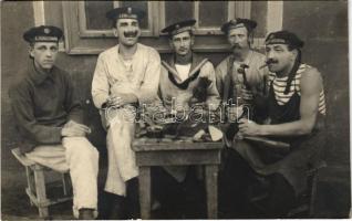 Pola, Pula; K.u.K. Kriegsmarine Matrosen / WWI Austro-Hungarian Navy, Four sailors sit around the shoemaker's workbench at a flying boat (hydroplane) station. photo (EK)