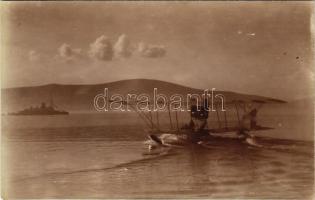 K.u.K. Kriegsmarine Seeflugzeug / WWI Austro-Hungarian Navy Lohner Te-type flying boat (hydroplane) L-61 moves forward under her own power, most likely preparing to take off at Kumbor air station in the Bay of Kotor, SMS Budapest in the background. photo (fl)