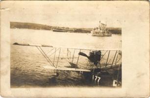 K.u.K. Kriegsmarine Seeflugzeug / WWI Austro-Hungarian Navy, Lohner Te-type flying boat (hydroplane) L-77 on the water in Pola harbor. SMS Adria and SMS Feuerspeier are visible in the background at their usual docking places. An Erzherzog-class battleship (or SMS Sankt Georg) is anchored closer to the flying boat. photo (szakadás / tear)