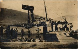 K.u.K. Kriegsmarine Seeflugzeug / large group of officers and seamen on shore and on a small pier watching the salvaging of a flying boat photo (fl)