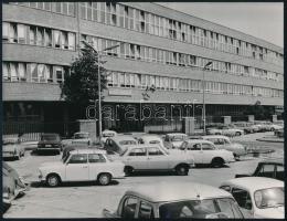 1973 Bp. XVI. ker., "Kiváló vállalat" épülete parkoló autókkal, sajtófotó, a hátoldalon feliratozott, pecséttel jelzett, 23,5x18 cm