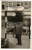 ~1940 Dés, Dej; utcakép, férfi kalappal az útjelző tábla alatt, mögötte ökrös szekér / street view, man with hat, signpost, ox cart. Nova photo