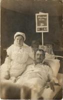 Sérült osztrák-magyar katona vöröskeresztes nővérrel egy hadikórházban / WWI Austro-Hungarian K.u.K. military, injured soldier with Red Cross nurse in a military hospital. photo (fl)