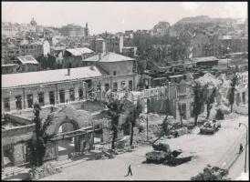 1945 Szendrő István (1908-2000): Budapest az ostrom után, a szétlőtt Déli Pályaudvar és Budai Vár, harckocsik, a hátoldalon pecséttel jelzett fotó, sarkán kis hibával, 17x23 cm