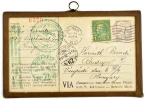 1931 A Justice for Hungary óceánrepülők által szállított képeslap Chicagoból Budapestre, alkalmi bélyegzésekkel, üveg keretben. / 1931 Postcard delivered by Justice for Hungary ocean flyers from Chicago to Budapest, with occasional cancellations, in a glass frame.