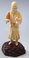 Okimono - Férfi alak. Faragott elefántagyar részekből összeállított, fa talapzaton, Japán, Meidzsi-kor, m: 20 cm /// Okimono - Male figure. Assembled from carved ivory tusk pieces, on a wooden base, Japan, Meiji period, height: 20 cm.