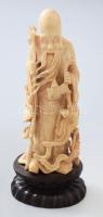 Shou Lao. Faragott elefántagyar, fa talapzaton, Kína, cca 19. sz. második fele, m: 18,5 cm /// Shou Lao. Carved ivory tusk on a wooden base, China, circa second half of the 19th century, height: 18.5 cm.