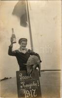 1917 Prosit Neujahr! K.u.K. Kriegsmarine Matrose Donauflottille / "A Temesünk kis bolondja" Császári és Királyi Haditengerészet Dunaflottilla SMS "TEMES II" (SMS BOSNA) monitor matróza Újévkor pezsgővel és malaccal / WWI Austro-Hungarian Navy Danube Flotilla river guard monitor SMS TEMES II (SMS BOSNA). A happy sailor toasts the New Year 1917 from the crows' nest of SMS TEMES II, all set for the festivities with a bottle of champagne in his right hand and a piglet under his left arm, near Turnu Severin, Romania. The monitor has to be SMS BOSNA, which between July 9, 1915, and May 9, 1917, was known as SMS TEMES II, pending the reconstruction of the latter monitor. photo (gyűrődés / crease)