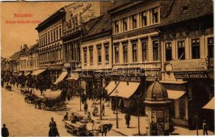 1912 Kolozsvár, Cluj; Mátyás király téri részlet, Püspöky Miklós harisnya kötödéje, Csizhegyi fényképész, üzletek, Iparbank részvény társaság, M. kir. államvasutak szállító hivatala, Ferenczi cipészmester, hirdetőoszlop, Kereskedelmi bank. Stief és társa papíros áruház reklámja és saját kiadása. W. L. (?) / main square, street view, bank, shops