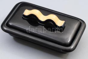 Zsolnay Manufaktúra, Gádor István (1891 - 1984) és Gorka Géza (1894 - 1971) tervezők: Vajtartó. cca 1930, öntött elemekből összeállított, fekete és barackszínű fedőmázzal, jelzett. masszába nyomott ZSOLNAY felirat, minimális kopással, 17,5x10,5 cm /// Zsolnay Manufactory, designers: István Gádor (1891?1984) and Géza Gorka (1894?1971): Butter Dish. Circa 1930, assembled from molded components, with black and peach-colored glaze, marked. Impressed "ZSOLNAY" inscription in the clay, minimal wear. Dimensions: 17.5 × 10.5 cm.