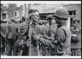 cca 1944 Robert Capa (1913-1954) (eredeti neve Friedmann Endre) magyar - francia fotóriporter felvétele (fogságba esett német katonát motoz egy amerikai katona), 1 db modern nagyítás, jelzés nélkül, Fotó újság archívumából, 15x21 cm