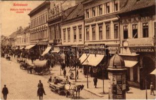 1908 Kolozsvár, Cluj; Mátyás király téri részlet, Püspöky Miklós harisnya kötödéje, Rácz János, Telcser Testvérek, Reményik L. és Fiai üzlete, Iparbank részvény társaság, M. kir. államvasutak szállító hivatala, Ferenczi cipészmester, hirdetőoszlop, Kereskedelmi bank / main square, street view, bank, shops (EK)
