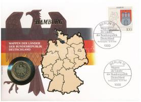 Németország 1991D 1M aranyozott Cu-Ni, tartományi címereket ábrázoló bélyeggel felbélyegzett "HAMBURG" borítékban, bélyegzéssel, német nyelvű leírással T:UNC Germany 1991D 1 Mark gilt Cu-Ni in "HAMBURG" envelope with stamps depicting provincial coats of arms and cancellation, with German description C:UNC
