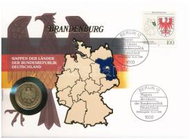 Németország 1991D 1M aranyozott Cu-Ni, tartományi címereket ábrázoló bélyeggel felbélyegzett "BRANDENBURG" borítékban, bélyegzéssel, német nyelvű leírással T:UNC Germany 1991D 1 Mark gilt Cu-Ni in "BRANDENBURG" envelope with stamps depicting provincial coats of arms and cancellation, with German description C:UNC