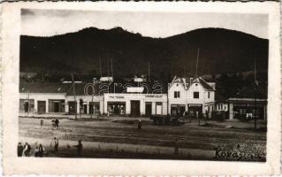 1942 Kovászna, Covasna; Fő tér, Imreh Béla, Laczkovits, Kovács üzlete, gyógyszertár, Szabó nyomda / main square, shops, pharmacy. photo (fl)