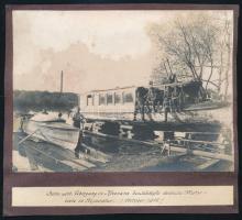 S.M.D. Medve a Dunai Flottila szállító hajójának fényképe Kevevárán / Hátoldalán német katonák hajót javítanak 1915  SMD. Medve moored next to Schiffstation Kommando in Kerevára. Several men (and one woman) are standing on deck, looking and motioning to the camera. / on the back side . German soldiers sit on a boat named Aviso that has been pulled out of the water, ostensibly for repairs. Two other men are next and on a small motor boat with the number 99 16x12 cm