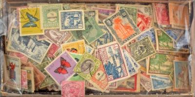 Több ezer db gyarmati bélyeg kis dobozban ömlesztve