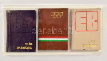 3 db sport témájú minikönyv: Világbajnokaink.; Olimpiai bajnokaink.; Európa-bajnokaink. Kis példányszámú (600-1000 pld.), számozott példányok. Kissé sérült műanyag tokban.