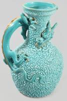 cca 1885 Zsolnay sárkánykorsó. Korongozott és kézzel formált, plasztikus elemekkel díszített porcelánfajansz. Tigermázas türkiz alapon plasztikus sárkányalak aranyozva. Alján jelzett: masszába nyomott Zsolnay Pécs és 787 (1882. évi formaszám). Aranyozáson kopással, egészen minimális mázhibával, m: 20,5 cm /// cca 1885 Zsolnay dragon jug. Thrown and hand-formed porcelain faience, decorated with plastic elements. Tiger glaze on turquoise ground with a gilt relief dragon figure. Marked on the base: impressed 'Zsolnay Pécs' and '787' (form number from 1882). With some wear to the gilding and minimal glaze imperfections, h: 20.5 cm. A tétel a Darabanth Galériában tekinthető meg. (Paulay Ede u. 25-27. https://www.darabanth.com/galeria/)