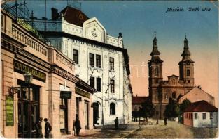 1915 Miskolc, Deák utca, M. kir. állami felső kereskedelmi iskola, cipészek és asztalosok árucsarnoka, üzletek, templom. Grünwald Ignác kiadása (EM)