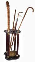 Oszlopos díszítésű sétabot tartó, benne 5 darab régi sétabot, közte vaddisznófog markolatos ezüst (Ag) szerelékes, fonatos ezüst (Ag) gyűrűs, monogramos.