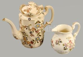 cca 1885 Zsolnay aranykontúrozott virágmintás kanna és kiöntő. Jelzett, formaszám: 4489, 4933, kopott, m: 12,5, 19 cm /// c. 1885 Zsolnay gold-outlined floral patterned jug and creamer. Marked, form numbers: 4489, 4933, worn, height: 12.5, 19 cm.