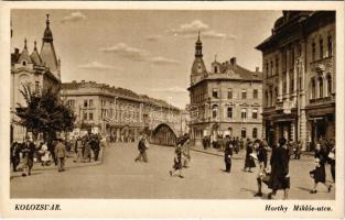 Kolozsvár, Cluj; Horthy Miklós utca, híd, gyógyszertár, közlekedési rendőr "K" karszalaggal, üzletek. Boros nyomda kiadása / street view, bridge, pharmacy, shops, policeman