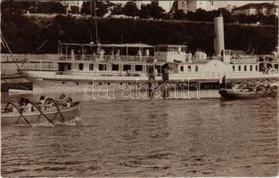 1916 Ruse, Rousse, Rusze, Russe, Roustchouk, Rustschuk; "HEBE" a DDSG oldalkerekes gőzhajója. Az első világháborúban a hadvezetőség parancsnoki hajója (Dunaflottilla) / WWI Austro-Hungarian Navy, Hungarian sidewheeler steamship. Hebe was requisitioned during the First World War, and was used as command ship and headquarters of the k.u.k. Kriegsmarine Danube Fleet until the end of the war, when she helped repatriate Czech and Austrian sailors returning from Rumania and the Black Sea. Officers in white watch from the deck of SM Stabschiff Hebe, moored at the river port, while seamen cheer the rowers from the bluff overlooking the river. photo