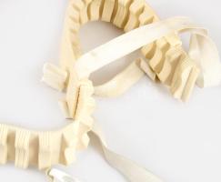 Kosmodisk gerincbántalmi segédeszköz, dobozában