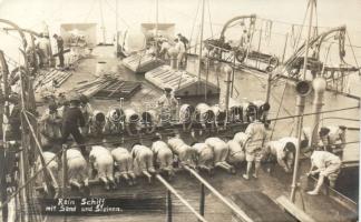 Sailors washing the floor with sand and stones photo
