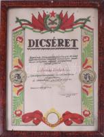 1955 Bp., Honvéd "Kossuth" Tüzér Tiszti Iskola dicsérő oklevele Király Ibolya részére ,,Hazánk felszabadulásának 10 éves évfordulójára indított szocialista munkaversenyben végzett szorgalmas munkájáért", bélyegzett aláírással, üvegezett keretben, a lapon kis lyukakkal, külső méret: 38x29,5 cm
