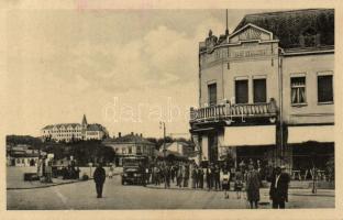 Léva main square hotel with automobiles and gas station