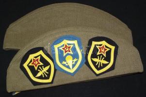 2 db szovjet katonai sapka, egyiken 24 db fegyvernemi, sport és egyéb jelvénnyel / Soviet miliitary ...