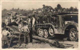 Military WWII Soviet front, off-road vehicle transporting a cannon photo (fl)