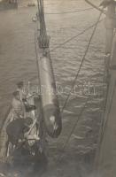 Loading a battleship with a torpedo, photo