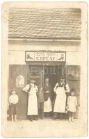 cca 1930 Csernits Ferenc cipészüzlete munkatársakkal, fotólap /  Shoe shop with owner and workers, photo card