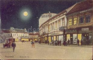 Nagyvárad Bemeneter square at night, hairdresser, Havana cigar and tobacco shop, Germania life insurance and corporation, clothing store of Koch, the shops of Ármin Flegman and János Fehér (EK)