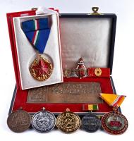 10db klf szocialista kitüntetés, jelvény, emlékplakett, több díszdobozban, közte: Szolgálati Érdemérem 10 év után + 1986-87. "Jó tanuló, jó sportoló" + 1951. "Közbiztonsági Érem arany fokozata a rendőrség tagjai részére" aranyozott zománcozott kitüntetés mellszalagon szalagsávval díszdobozban T: vegyes