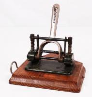 Cca 1920 Kanitz O. és fia jelzésű rugós Stolzenberg iratlukasztó, fatalpra rögzítve,