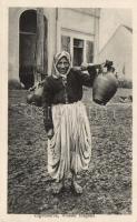 Gypsy woman carrying water