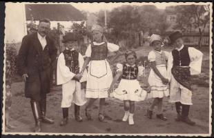 cca 1940 Ignáczy (Beregszász): Nagypapa és a szüreti bálba induló gyerekek népviseletbe öltözve, fotólap, 8,5x13 cm