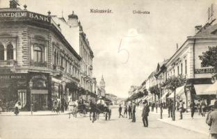 Kolozsvár, Unió utca, Kereskedelmi bank, Schultz Rezső üzlete, Rácz Béla borbély és fodrász, Joanovics üzlete, kiadja Gombos Ferenc / street, bank, shops