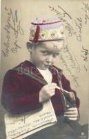 Boy smoking a pipe, as a Turkish boy