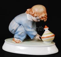 Zsolnay búgócsigával játszó gyerek, kézzel festett, jelzett (Sinkó), hibátlan, 13×15 cm / Handpainted Zsolnay chinaware figure in flawless condition